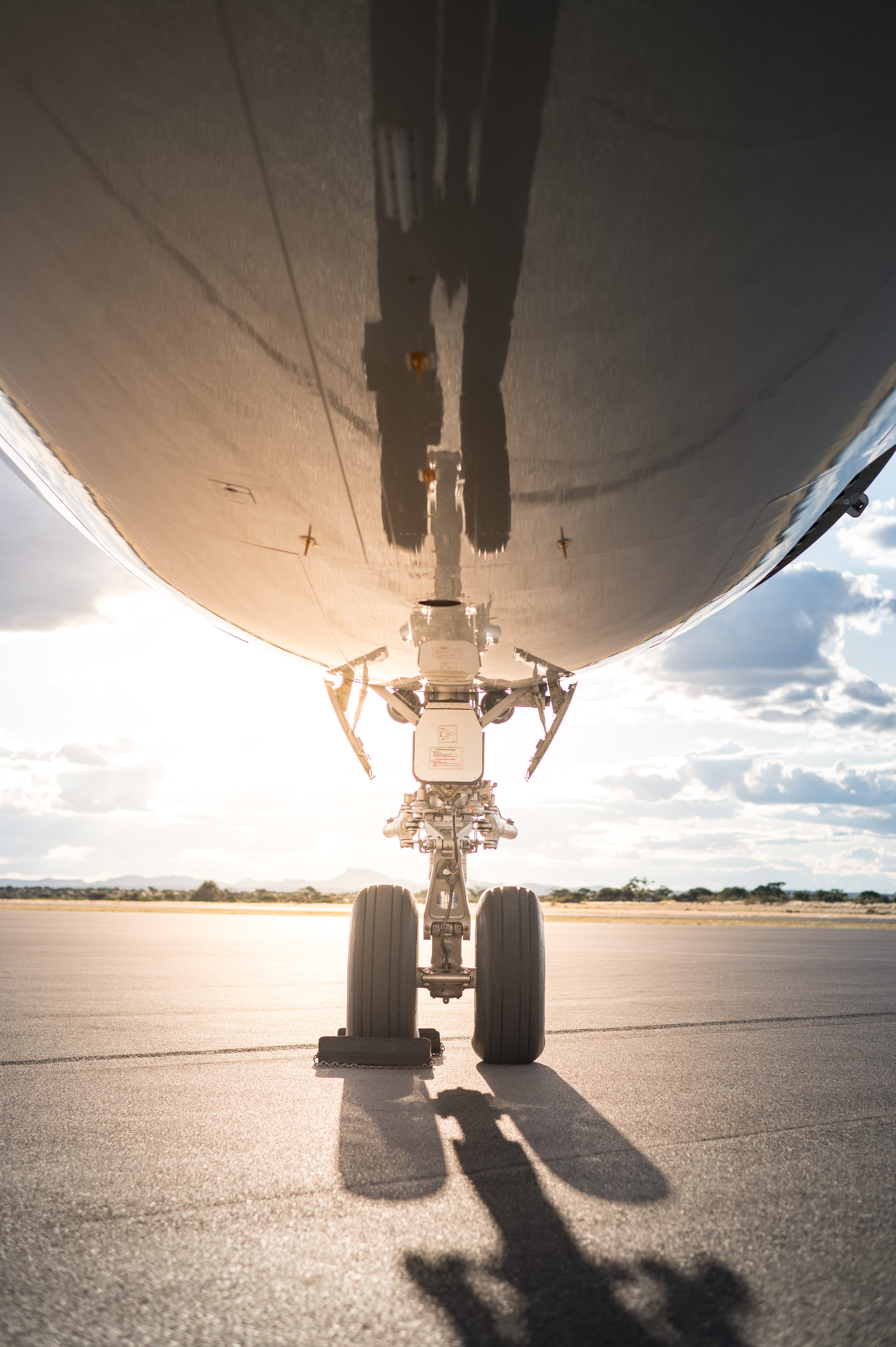 Image of an airplane nose wheel from close up.